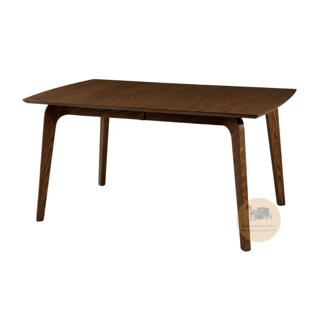 A mid-century modern wooden dining table with a dark brown finish, featuring tapered legs and a rectangular top with curved ends, shown on a plain white background with an Amish Furniture Creations logo in the lower right .