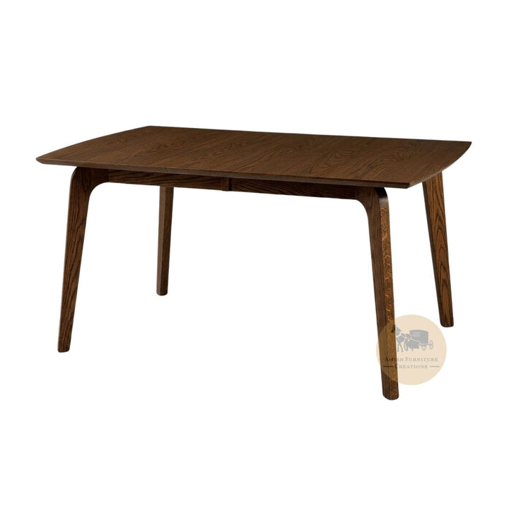 A mid-century modern wooden dining table with a dark brown finish, featuring tapered legs and a rectangular top with curved ends, shown on a plain white background with an Amish Furniture Creations logo in the lower right .
