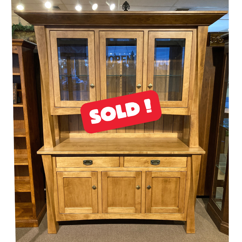 Clearance hard maple wood hutch with glass doors on top of a buffet with drawers and doors in a showroom setting - front view - with a large red SOLD sign - Amish Furniture Creations™