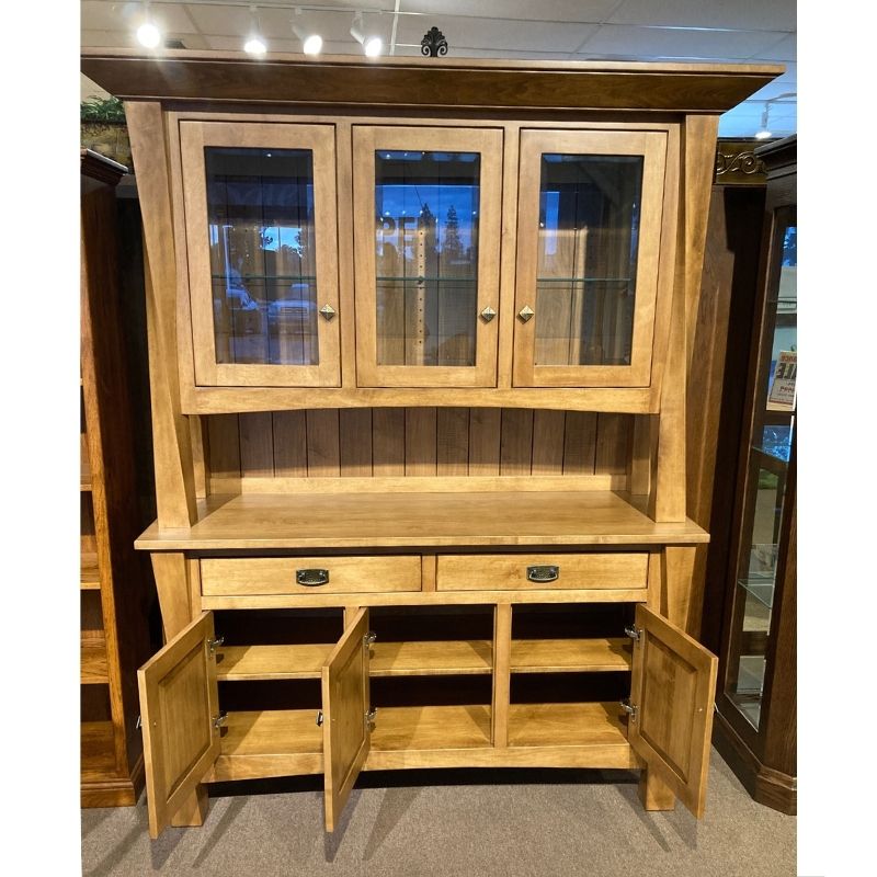 Clearance hard maple wood hutch with glass doors on top of a buffet with drawers and doors in a showroom setting - front view with bottom doors open to show the fixed shelf  - Amish Furniture Creations™