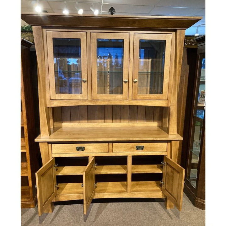 Clearance hard maple wood hutch with glass doors on top of a buffet with drawers and doors in a showroom setting - front view with bottom doors open to show the fixed shelf  - Amish Furniture Creations™