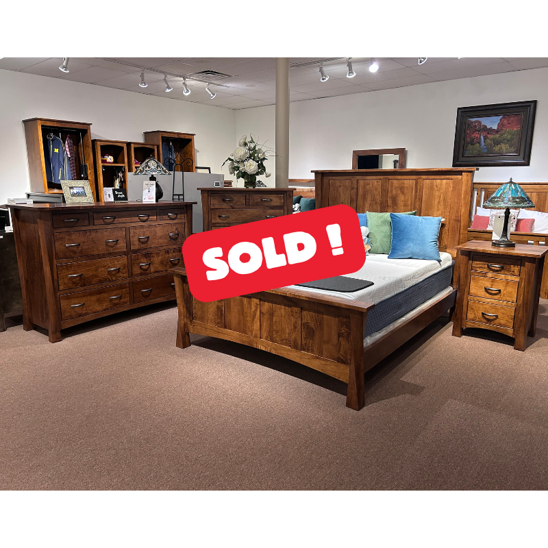 Clearance wooden Brown Maple bed, dresser, chest, and nightstand in a showroom with a large red SOLD sign - Oak For Less® Furniture