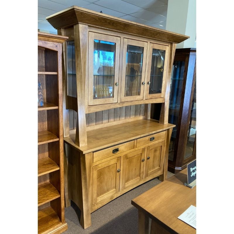 Clearance hard maple wood hutch with glass doors on top of a buffet with drawers and doors in a showroom setting - angled view - Amish Furniture Creations™