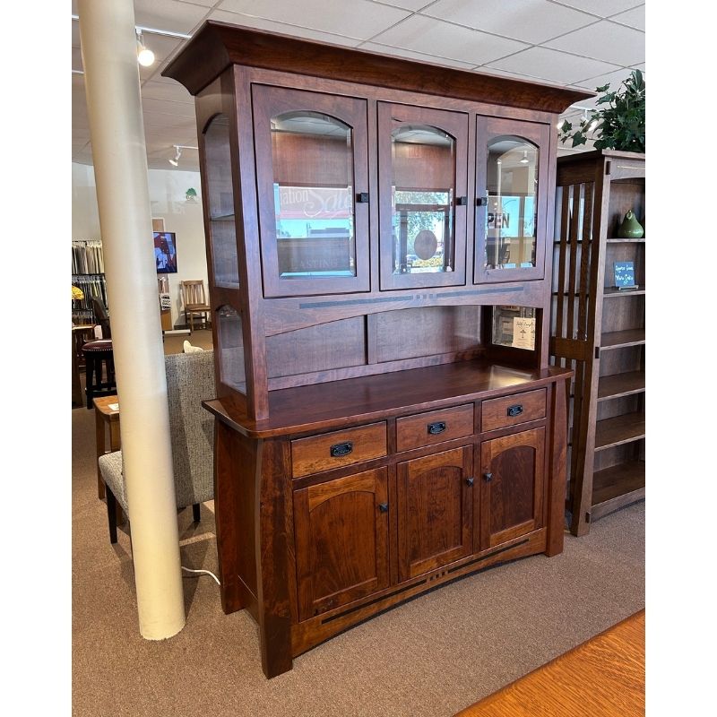 Clearance cherry wood hutch with glass doors on top of a buffet with drawers and doors in a showroom setting - angled view - Amish Furniture Creations™