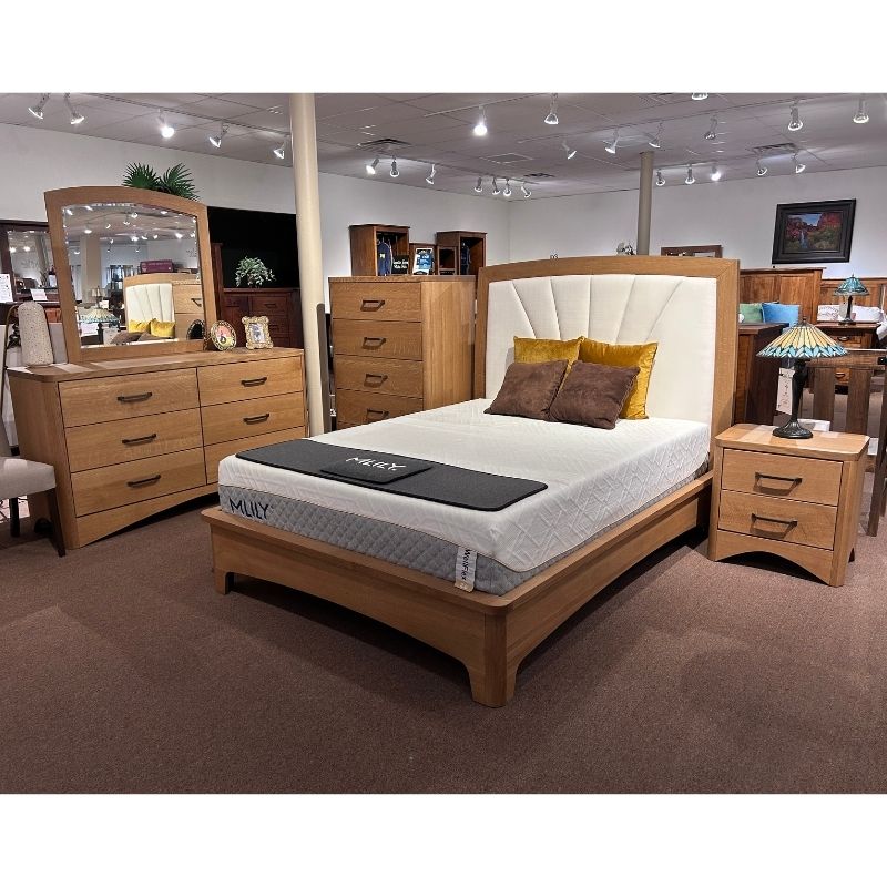Clearance wooden Quarter Sawn White Oak bedroom furniture set with fabric headboard bed, dresser, mirror, chest, and nightstand in a showroom - Amish Furniture Creations™