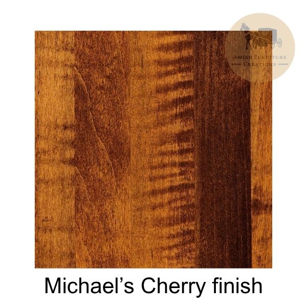 A wood finish sample labeled 'Michael's Cherry finish' showing a warm reddish-brown wood grain texture on a white background, with a circular 'Amish Furniture Creations' watermark in the top right.