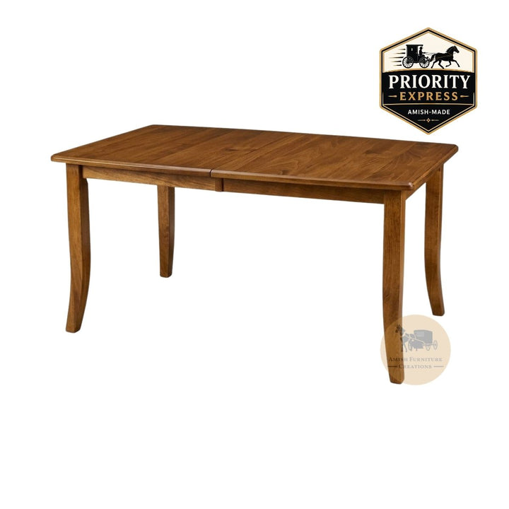 A medium brown wooden extendable dining table with 4 legs shown from a three-quarter angle on a white background, with a Priority Express brand badge in the top right corner and an Amish Furniture Creations logo in the lower right.